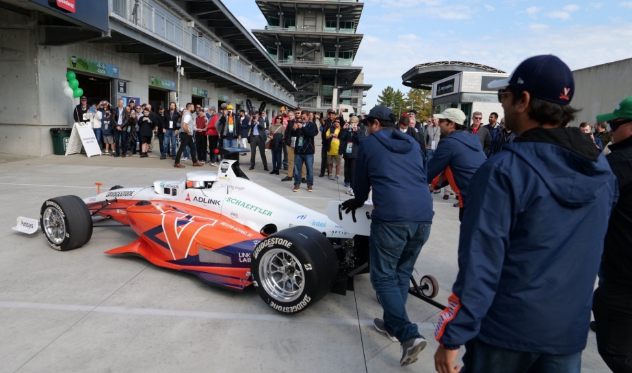 members of the UVA team on the race track with their car