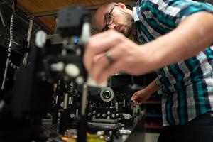 ExCiTe lab researcher adjusts equipment