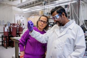 Prof. Beth Opila and a graduate student examine a sample in the lab