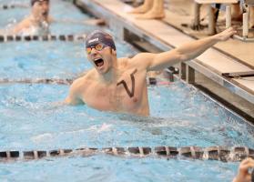 A competitive swimmer celebrating in the pool