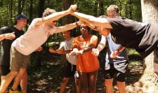 two students brace their hands against each other during a trust exercise