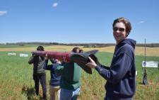 Student carrying a rocket