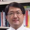 UVA Link Lab faculty member, Brian Park, is pictured here in front of a book shelf.