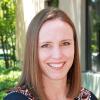 UVA Link Lab Program Manager, Kelley Tobler, is pictured here in a headshot taken outdoors alongside a building.